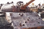 Irácký tank T-55 provrtaný municí s ochuzeným uranem na hřbitově vojenské techniky v severním Kuvajtu, které vzniklo po první válce v Perském zálivu v roce 1991 | Iraqi tank T-55 perforated by Depleted Uranium ammunition in "Boneyard" in Northern Kuwait. This boneyard arose after first Gulf war in 1991. Photo by Dušan Rovenský, 2002